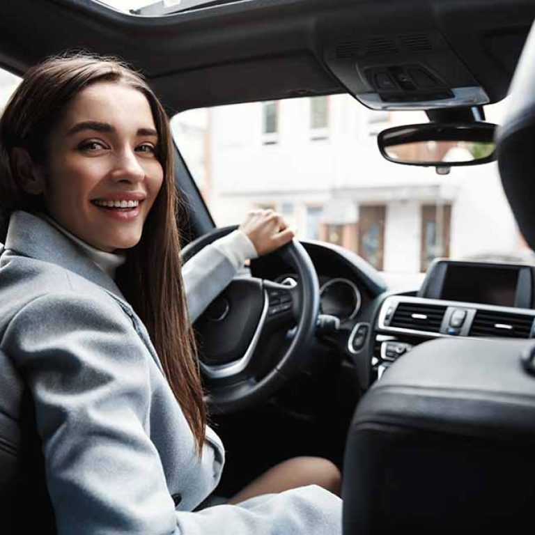 Post Breast Augmentation Driver looking in back seat checking on their recovery.